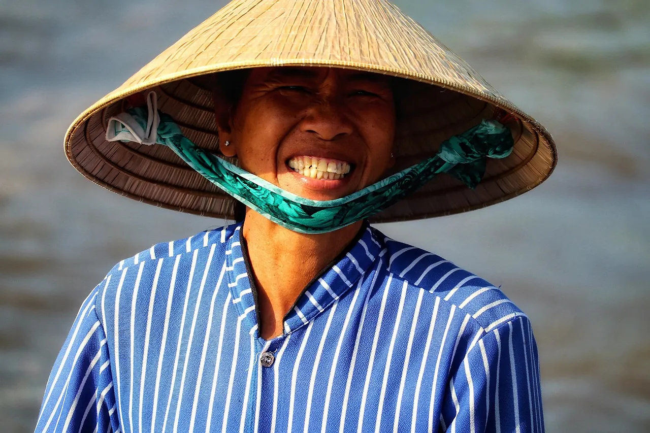 Người đàn ông đội nón lá mỉm cười rạng rỡ